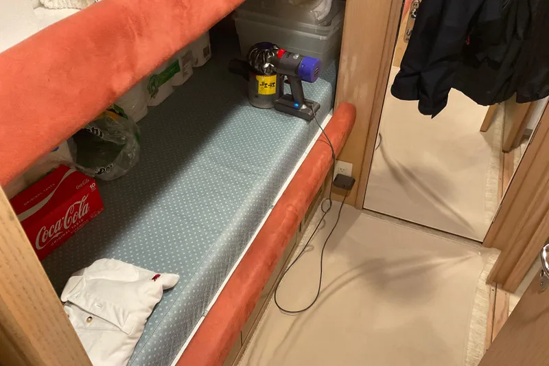 Slide: The Image of Interior of 1997 Hatteras 70 Sport Deck Motor Yacht with storage and cleaning supplies. - 35