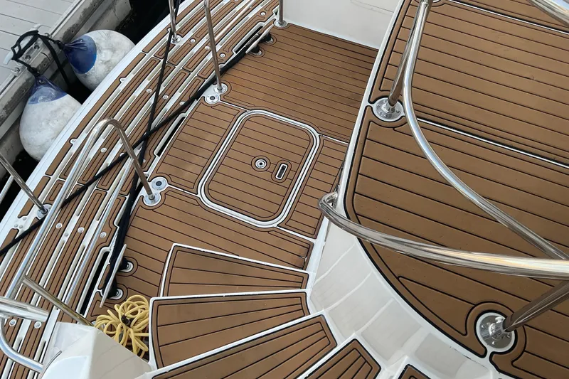 Slide: The Image of Deck of 1997 Hatteras 70 Sport Deck Motor Yacht with teak flooring and stainless steel railings. - 4