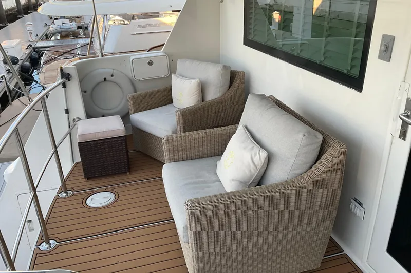 Slide: The Image of Cozy seating area on 1997 Hatteras 70 Sport Deck Motor Yacht with wicker chairs and cushions. - 6