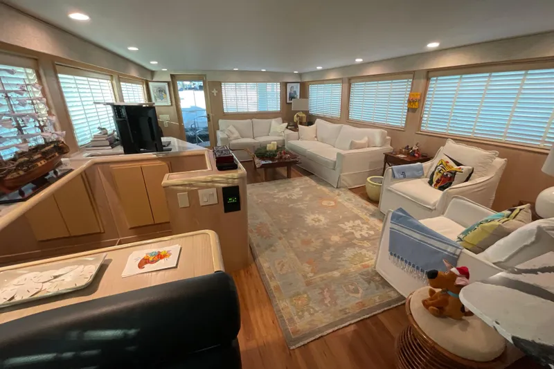 Slide: The Image of Luxurious interior of 1997 Hatteras 70 Sport Deck Motor Yacht with elegant seating and decor. - 9