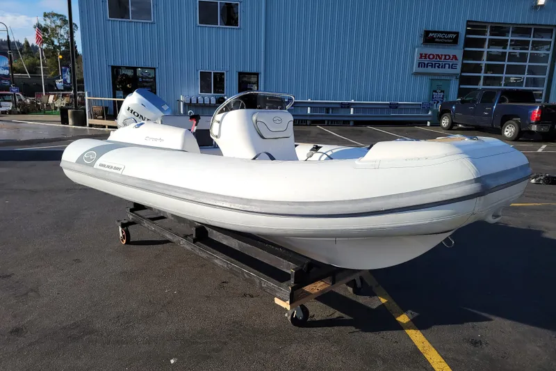 The Image of 2018 Walker Bay Generation 400 DLX inflatable boat on display at a marina. - 0