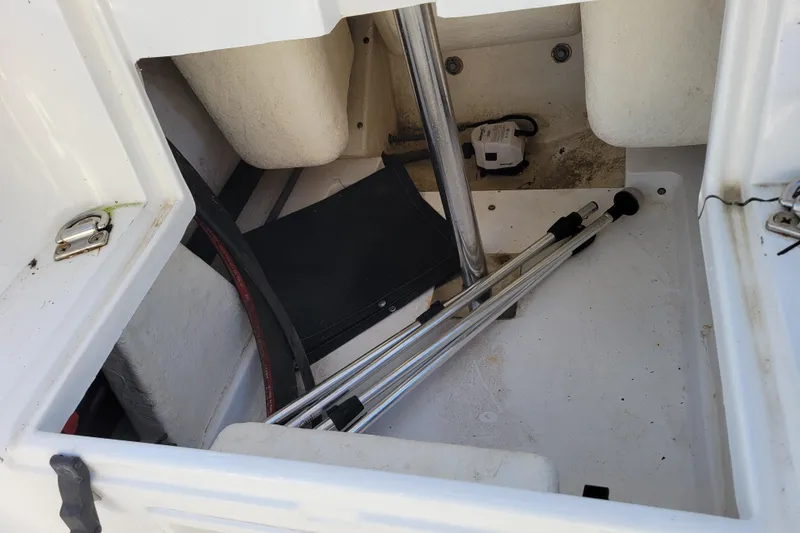 Slide: The Image of Storage compartment of 2018 Walker Bay Generation 400 DLX boat with metal poles and equipment. - 16