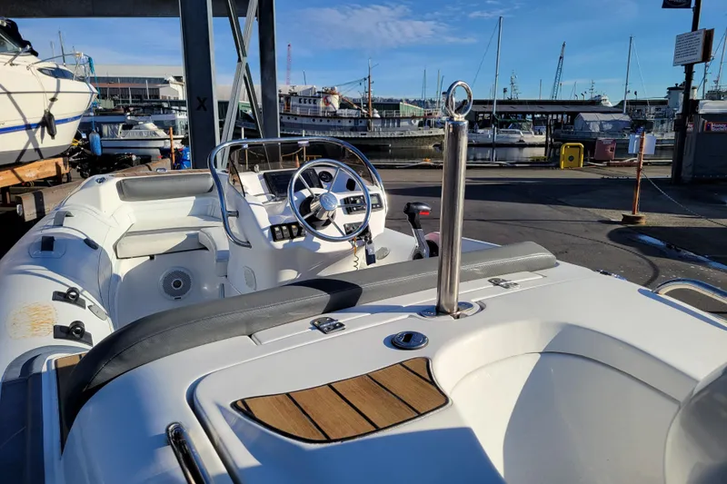 Slide: The Image of 2018 Walker Bay Generation 400 DLX boat at marina, featuring sleek design and modern controls. - 19