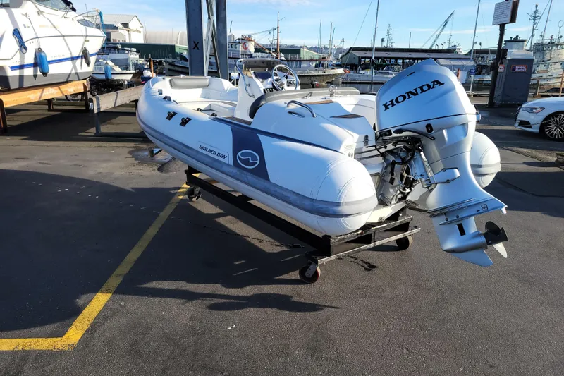Slide: The Image of 2018 Walker Bay Generation 400 DLX boat with Honda outboard motor at marina. - 3