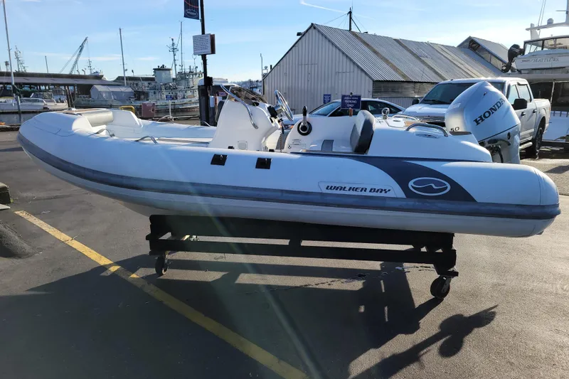 Slide: The Image of 2018 Walker Bay Generation 400 DLX inflatable boat on display at a marina. - 4
