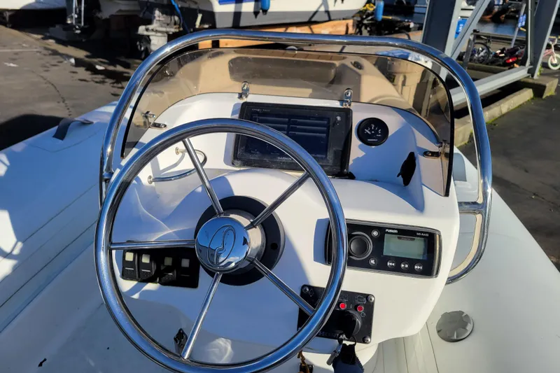 Slide: The Image of 2018 Walker Bay Generation 400 DLX boat dashboard with steering wheel and controls. - 9