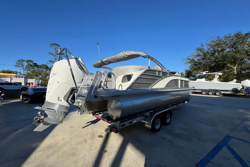 Slide: The Image of 2026 Bennington 23 LTFB pontoon boat on trailer, sunny day, outdoor setting. - 11