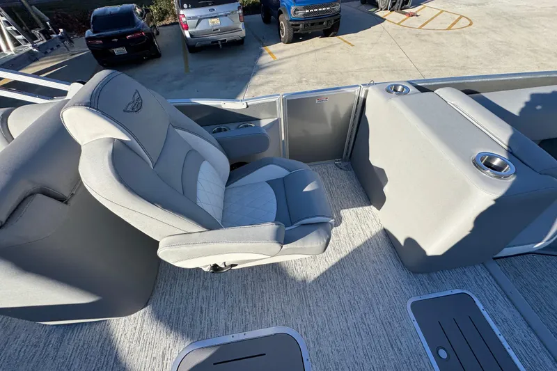 Slide: The Image of 2026 Bennington 23 LTFB boat interior with gray seating and cup holders. - 25