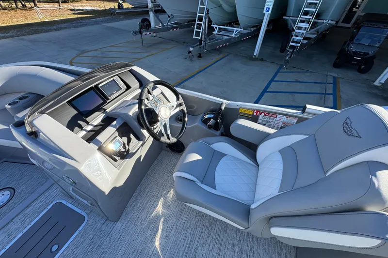 Slide: The Image of 2026 Bennington 23 LTFB boat interior with steering wheel and luxurious seating. - 26