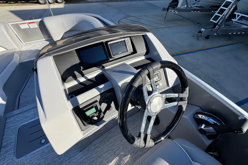 Slide: The Image of 2026 Bennington 23 LTFB boat dashboard with steering wheel and control panel. - 27