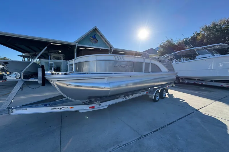 Slide: The Image of 2026 Bennington 23 LTFB pontoon boat on trailer under sunny sky. - 3
