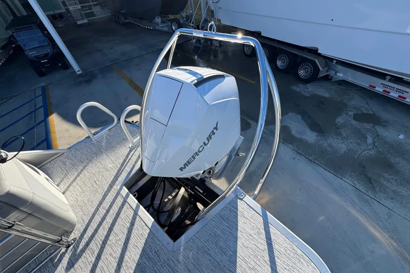 Slide: The Image of 2026 Bennington 23 LTFB boat with Mercury outboard motor, docked at marina. - 34