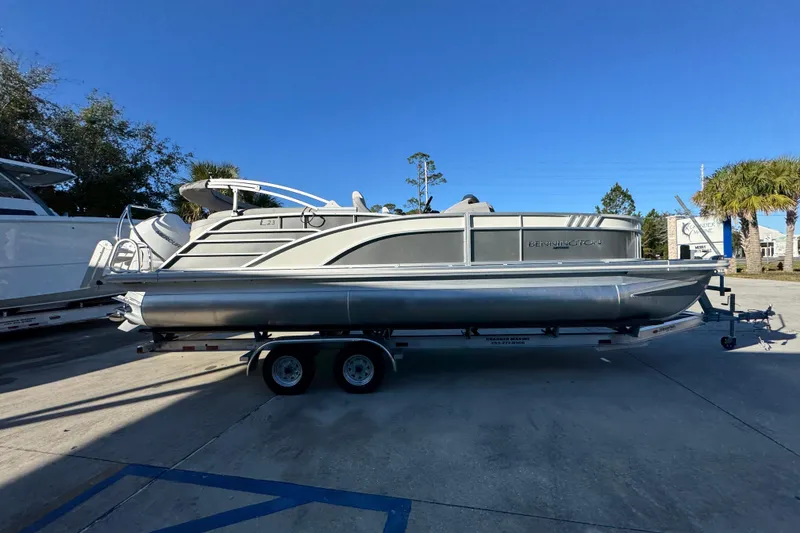 Slide: The Image of 2026 Bennington 23 LTFB pontoon boat on trailer under clear blue sky. - 9