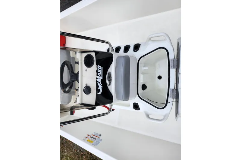 Slide: The Image of 2024 Mako Pro Skiff 17 CC boat interior with steering console and seating. - 14
