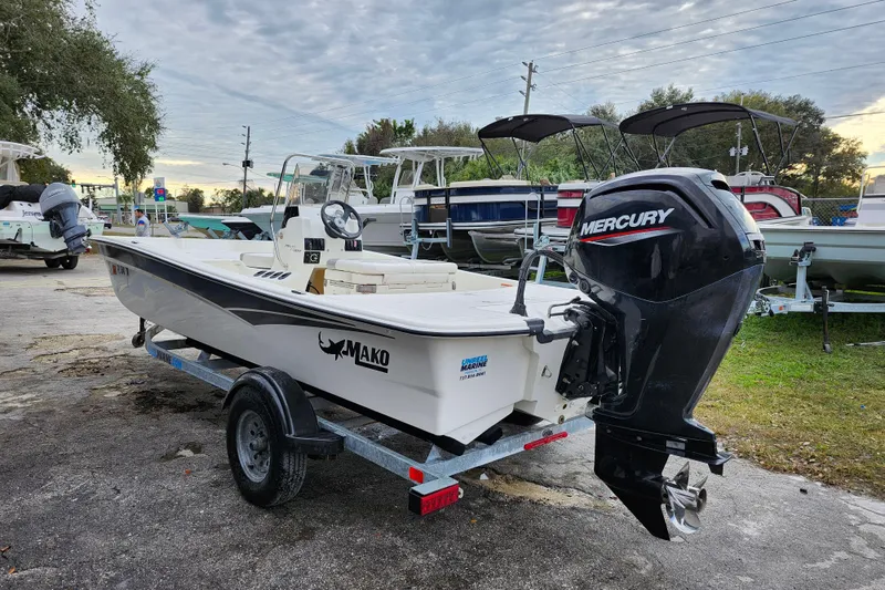 Slide: The Image of 2024 Mako Pro Skiff 17 CC boat with Mercury outboard motor on trailer. - 4