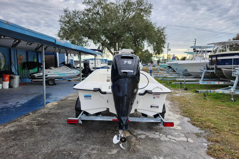 Slide: The Image of 2024 Mako Pro Skiff 17 CC boat with Mercury 75 engine on trailer. - 5