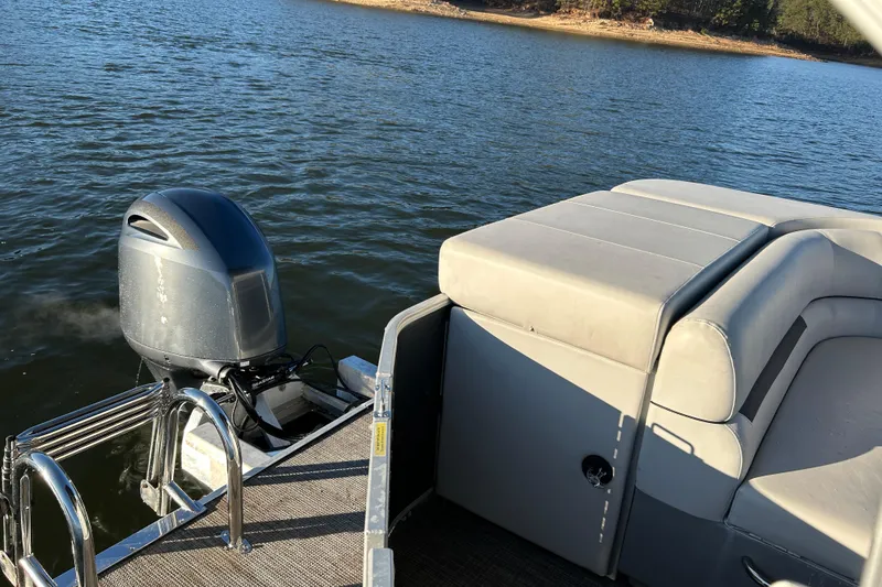 Slide: The Image of 2023 Godfrey Sweetwater 2286 C pontoon boat with outboard motor on a lake. - 15