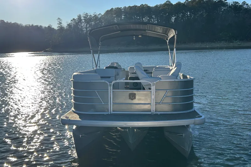 Slide: The Image of 2023 Godfrey Sweetwater 2286 C pontoon boat on a serene lake. - 3