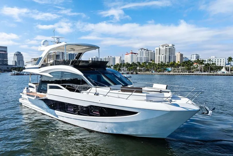 Slide: The Image of 2018 Galeon 640 Fly yacht cruising near city skyline on a sunny day. - 14