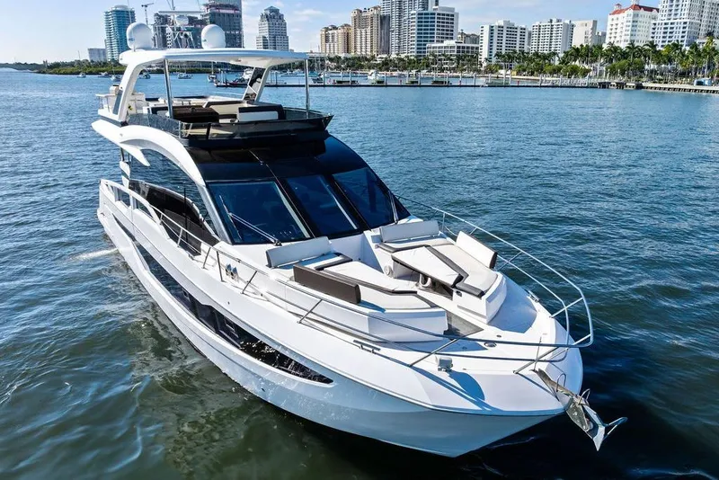 Slide: The Image of Luxury 2018 Galeon 640 Fly yacht cruising near city skyline. - 15