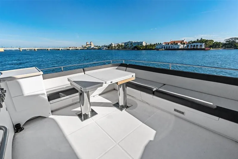Slide: The Image of Luxurious 2018 Galeon 640 Fly yacht deck with seating, overlooking serene waterfront views. - 28