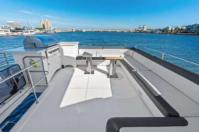 Slide: The Image of Luxurious 2018 Galeon 640 Fly yacht deck with seating and grill, overlooking marina. - 29