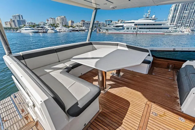 Slide: The Image of Luxurious 2018 Galeon 640 Fly yacht deck with seating, overlooking marina and cityscape. - 42