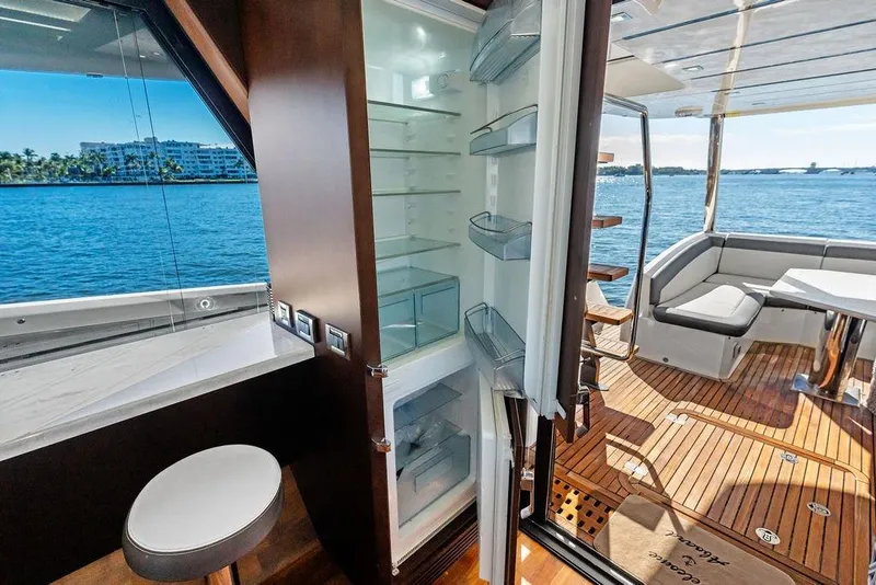 Slide: The Image of Luxurious 2018 Galeon 640 Fly yacht interior with open fridge and scenic ocean view. - 49