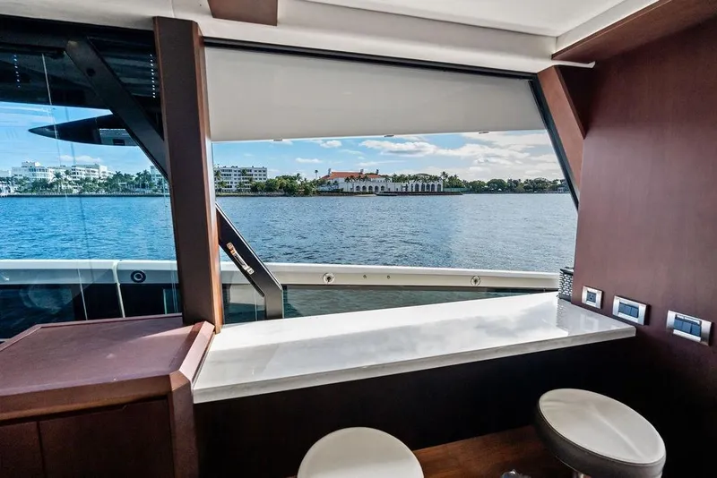 Slide: The Image of Interior view from 2018 Galeon 640 Fly yacht, overlooking serene waterfront scenery. - 50