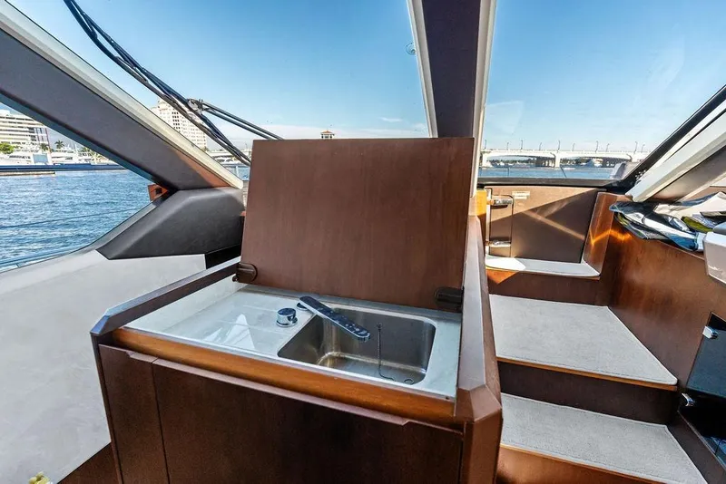 Slide: The Image of Interior of 2018 Galeon 640 Fly yacht with sink and stairs, overlooking marina. - 64