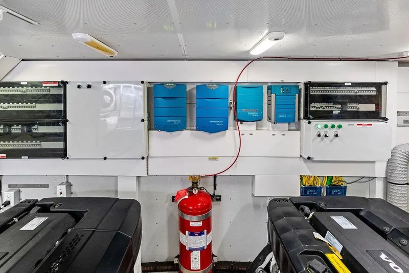 Slide: The Image of Engine room of 2018 Galeon 640 Fly yacht with electrical panels and fire extinguisher. - 89