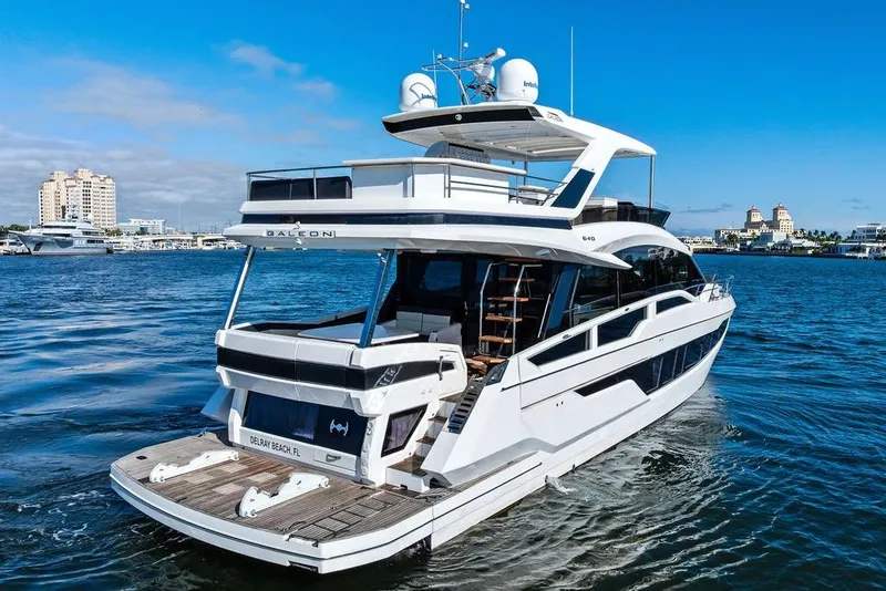 Slide: The Image of 2018 Galeon 640 Fly yacht cruising on a sunny day near a coastal city. - 9