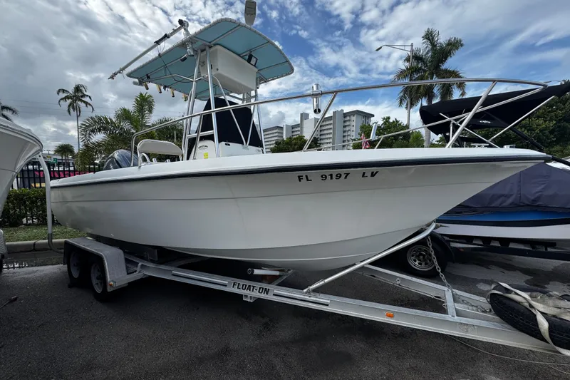 The Image of 2023 Hydra-Sports 212 CC boat on trailer, parked outdoors with palm trees in background. - 0