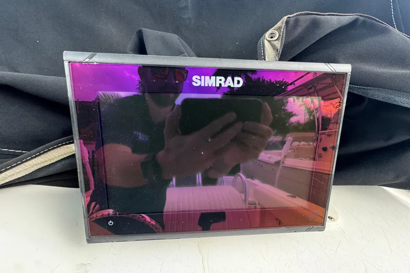 Slide: The Image of Simrad display on 2023 Hydra-Sports 212 CC boat, reflecting surroundings. - 10