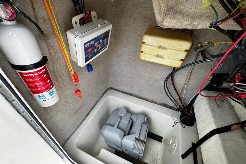 Slide: The Image of 2023 Hydra-Sports 212 CC boat compartment with fire extinguisher, first aid kit, and wiring. - 12