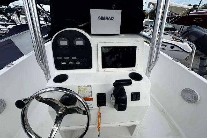 Slide: The Image of 2023 Hydra-Sports 212 CC boat console with steering wheel and Simrad navigation system. - 8