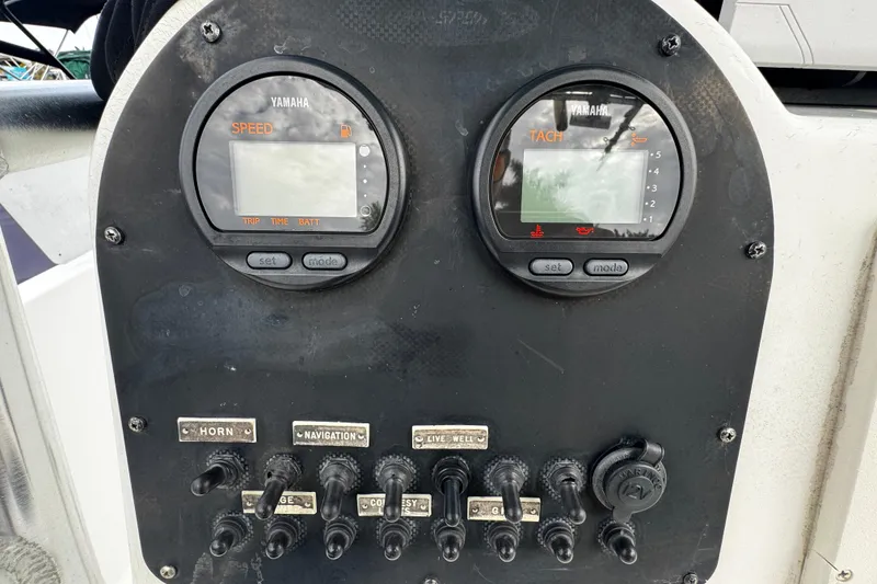 Slide: The Image of Control panel of 2023 Hydra-Sports 212 CC boat with Yamaha gauges and switches. - 9