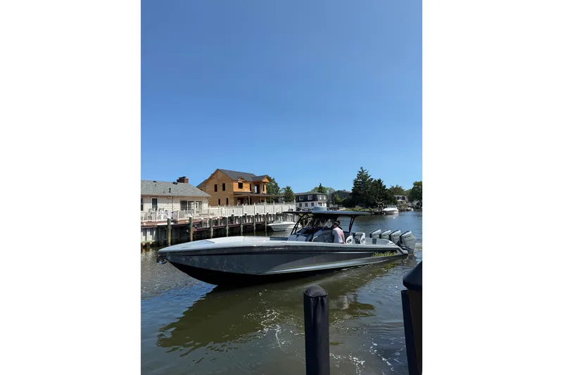 The Image of 2026 Nor-Tech 390 Sport Center Console boat docked on a sunny day. - 0