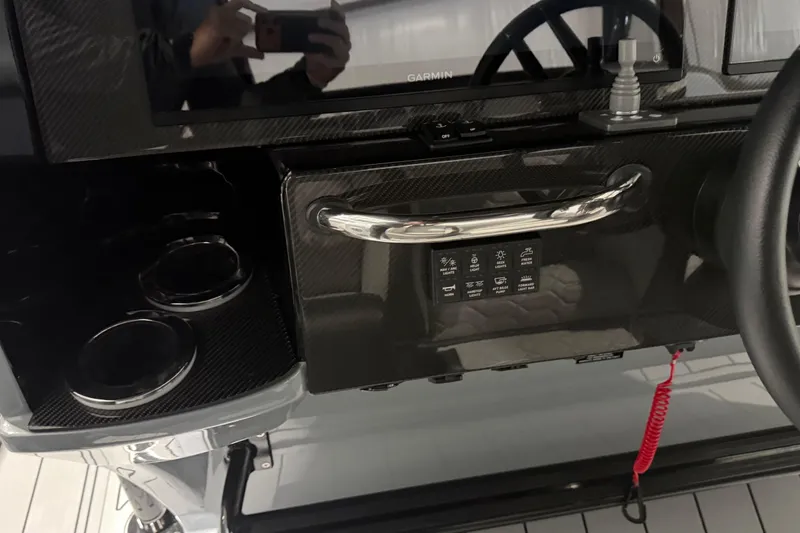 Slide: The Image of 2025 Nor-Tech 390 Sport Center Console dashboard with Garmin display and control panel. - 10