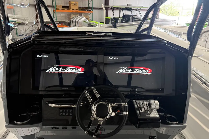 Slide: The Image of 2025 Nor-Tech 390 Sport Center Console dashboard with Garmin displays and steering wheel. - 11