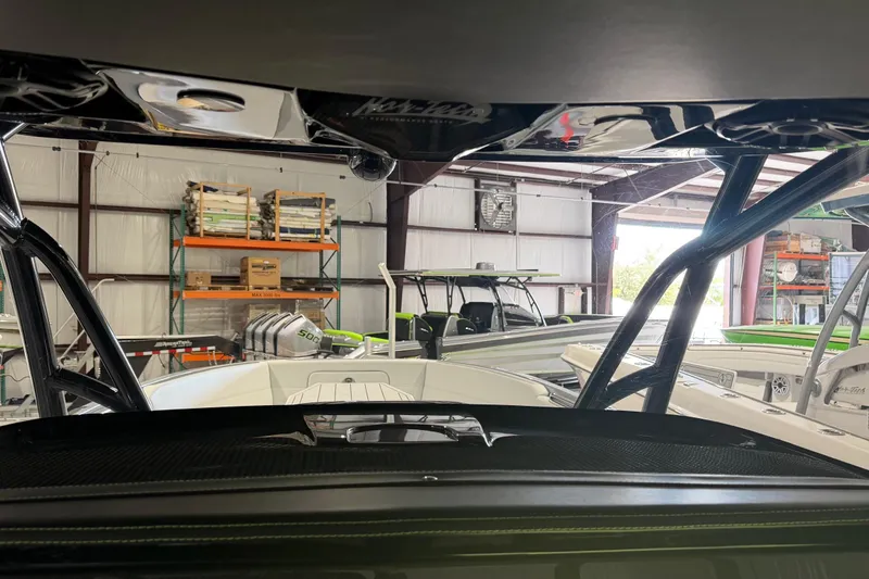 Slide: The Image of 2025 Nor-Tech 390 Sport Center Console in a warehouse setting. - 13