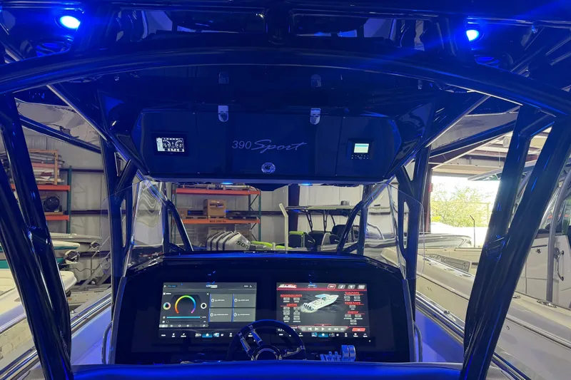 Slide: The Image of 2025 Nor-Tech 390 Sport Center Console with illuminated dashboard and advanced navigation system. - 19