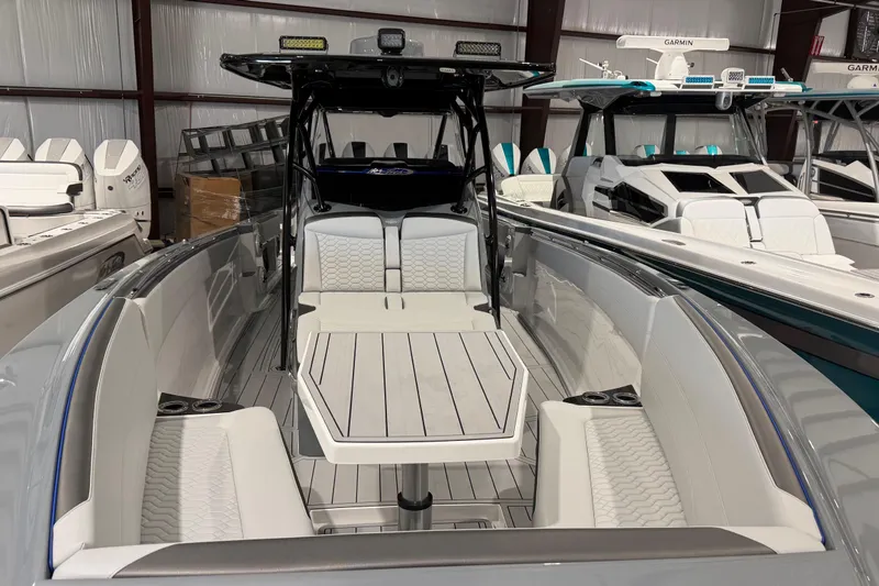 Slide: The Image of 2025 Nor-Tech 390 Sport Center Console boat with sleek seating and modern design. - 2