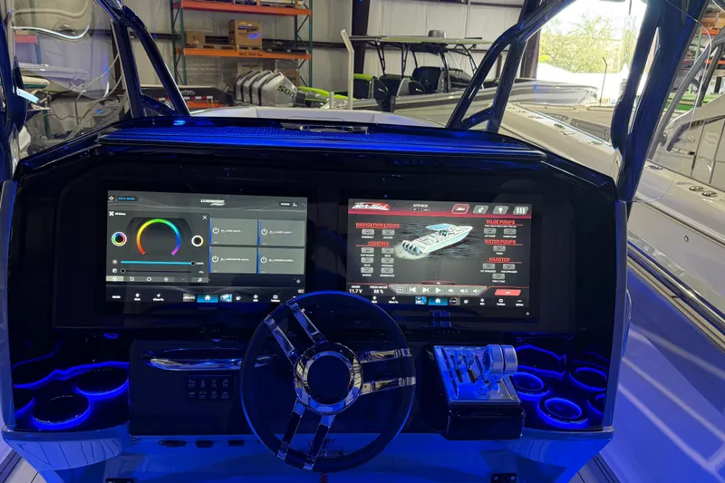 Slide: The Image of 2025 Nor-Tech 390 Sport Center Console dashboard with advanced digital controls and illuminated cup holders. - 20