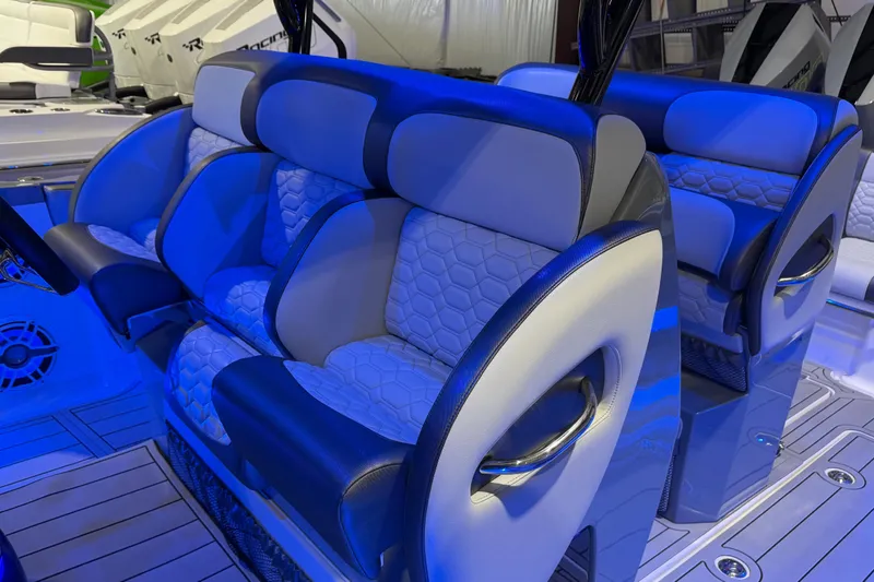 Slide: The Image of 2025 Nor-Tech 390 Sport Center Console interior with blue-lit luxury seating. - 21