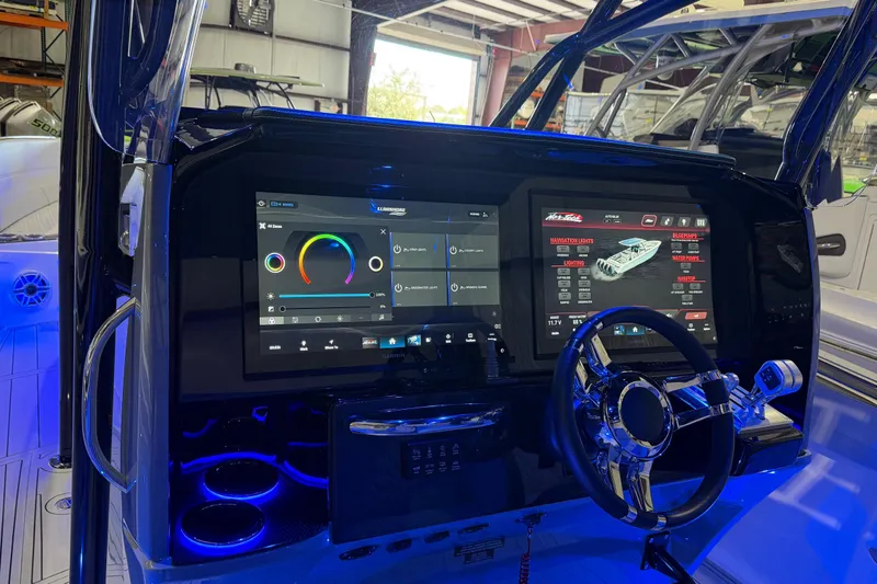Slide: The Image of 2025 Nor-Tech 390 Sport Center Console dashboard with advanced digital controls and illuminated features. - 24