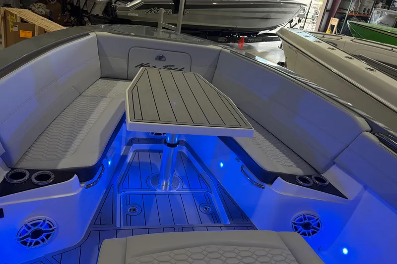 Slide: The Image of 2025 Nor-Tech 390 Sport Center Console with blue LED lighting and sleek seating area. - 29