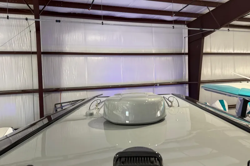 Slide: The Image of 2025 Nor-Tech 390 Sport Center Console in a warehouse, showcasing sleek design. - 34