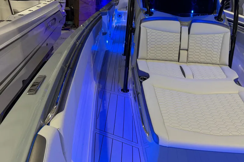 Slide: The Image of 2025 Nor-Tech 390 Sport Center Console with illuminated deck and luxurious seating. - 35