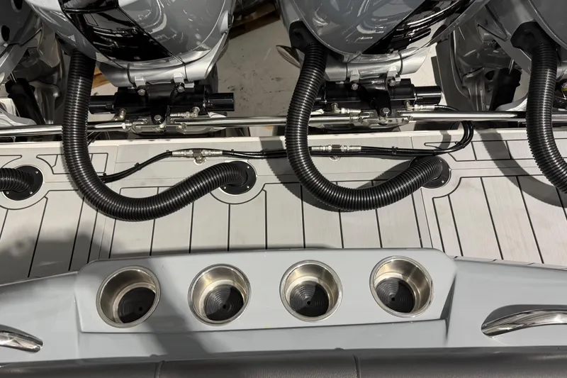 Slide: The Image of 2025 Nor-Tech 390 Sport Center Console boat with dual outboard engines and cup holders. - 4